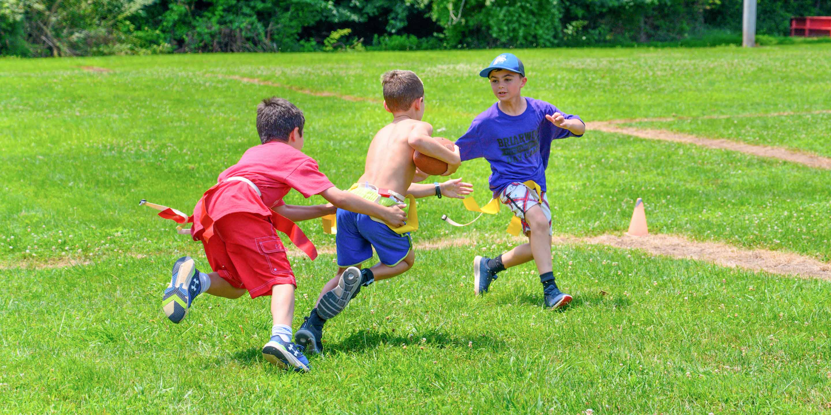 Boys playing flag football on field