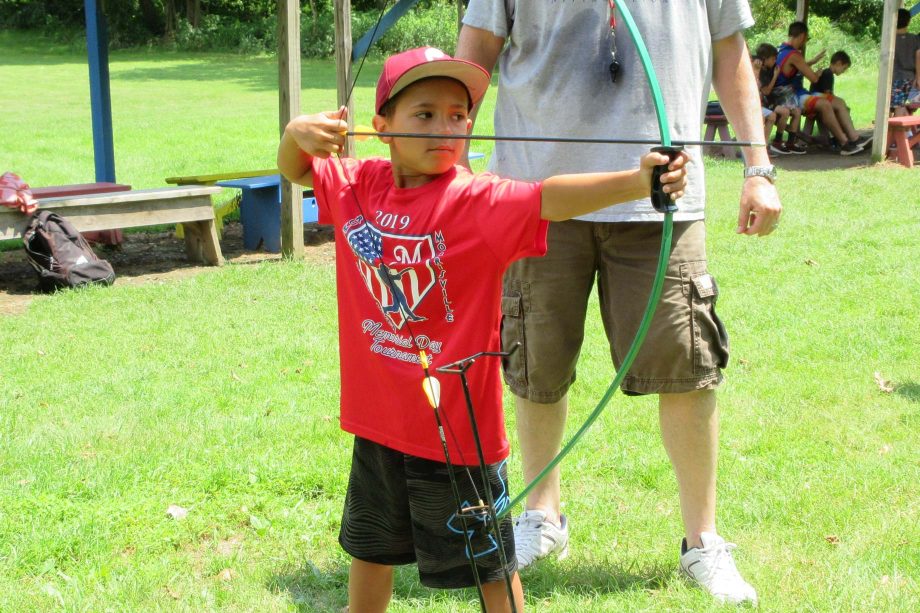 Boy shooting archery arrow