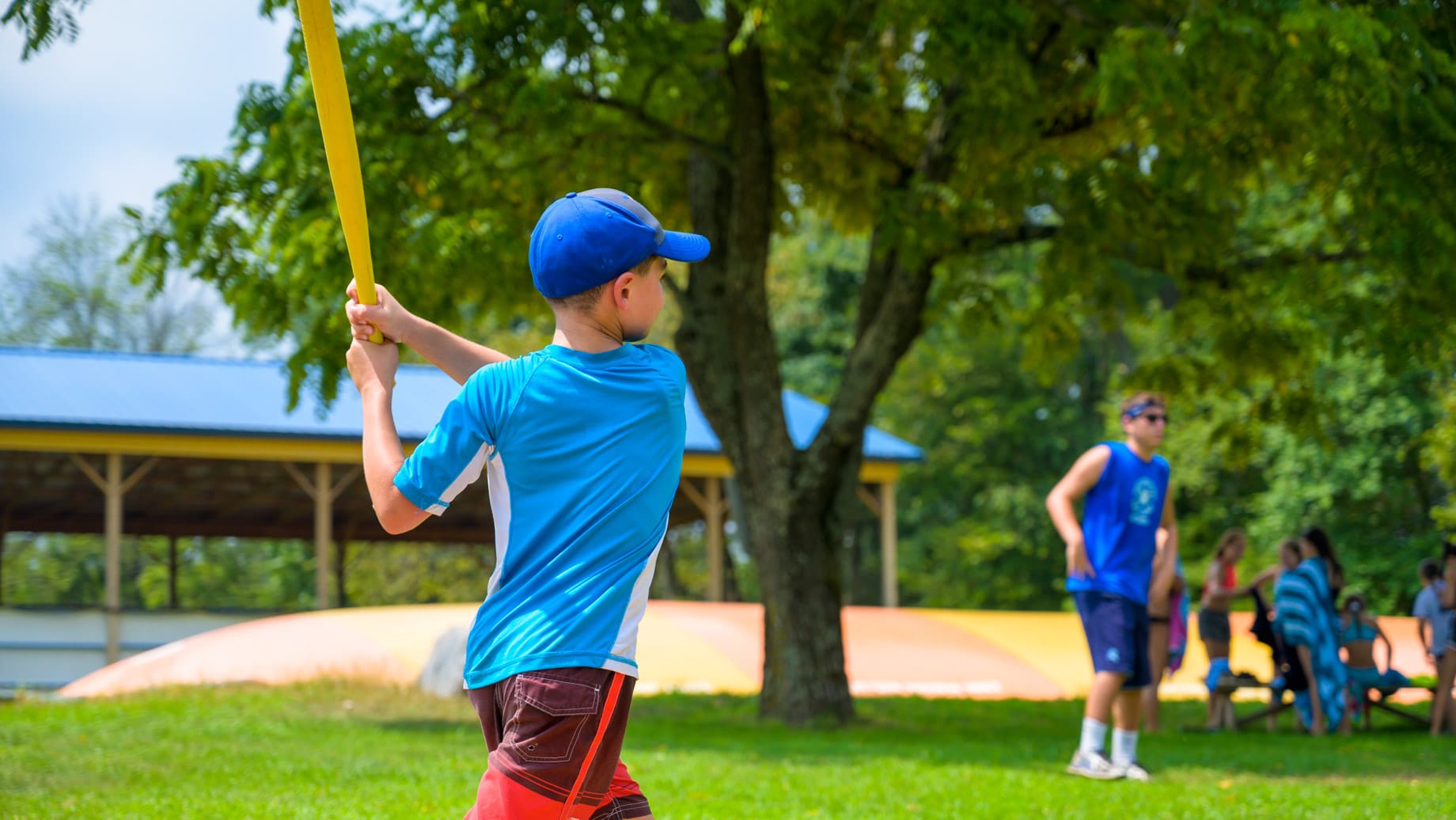 Camper hitting baseball bat