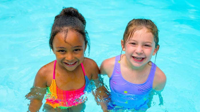 Two girls swimming in pool