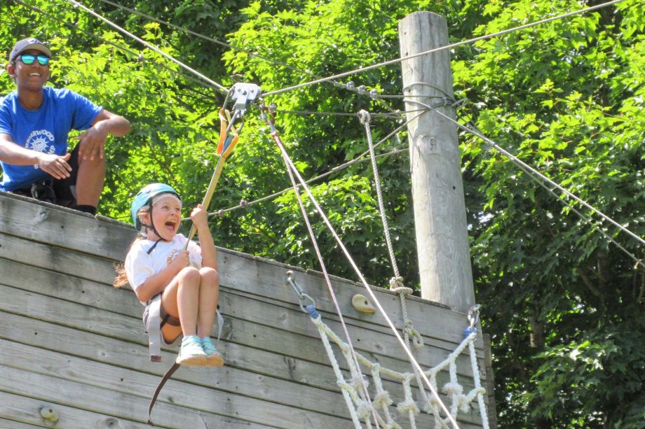 Girl going on zip line and screaming