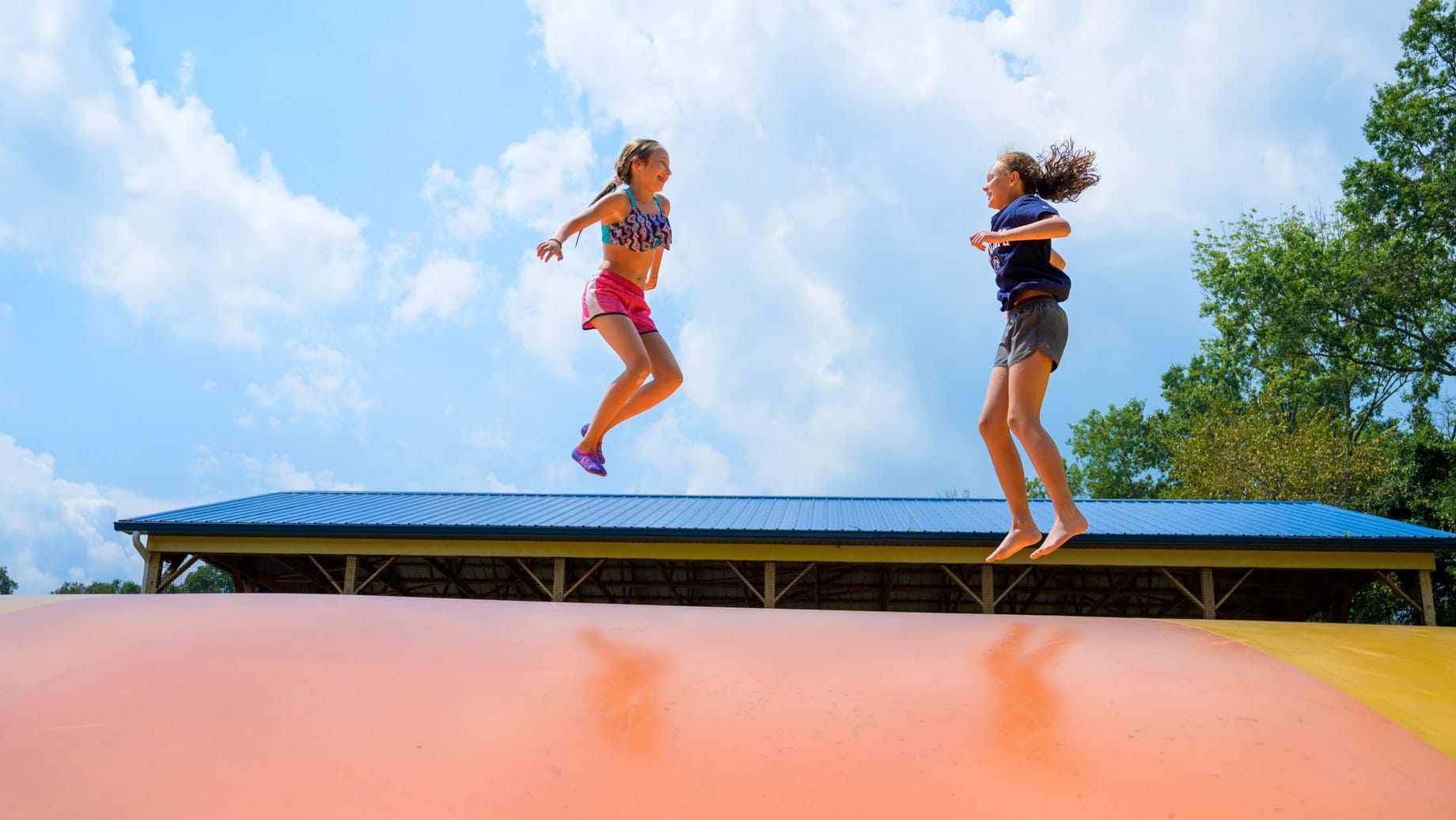 Girls on jumping pillow