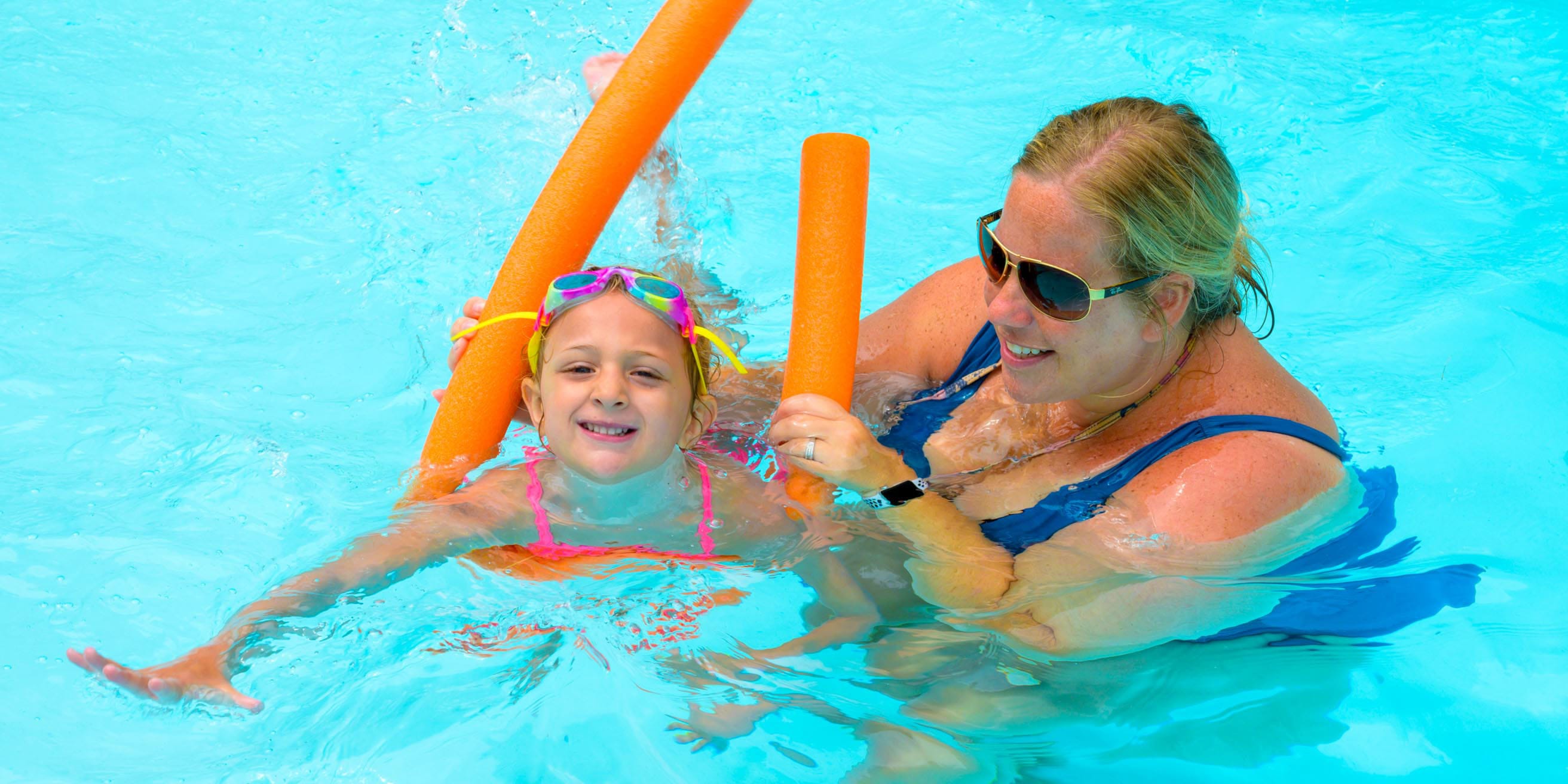 Girl and staff in pool