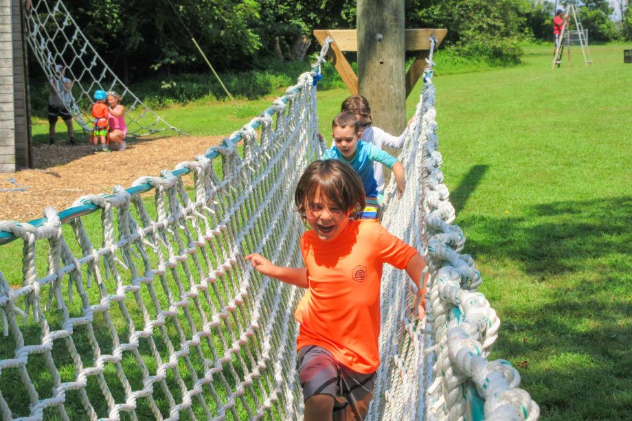 Kids crossing netting for outdoor adventure activity