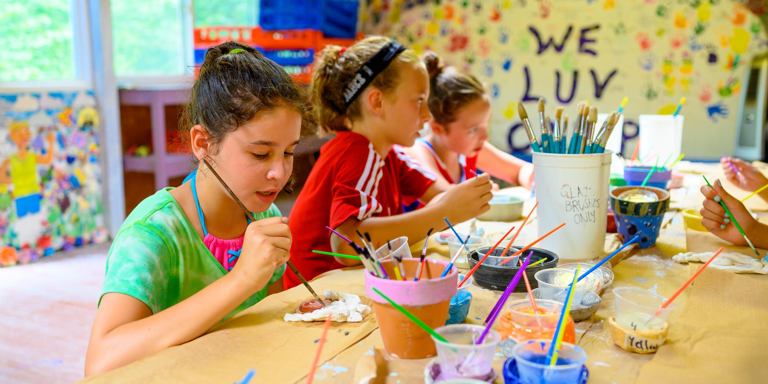 Girls painting pottery