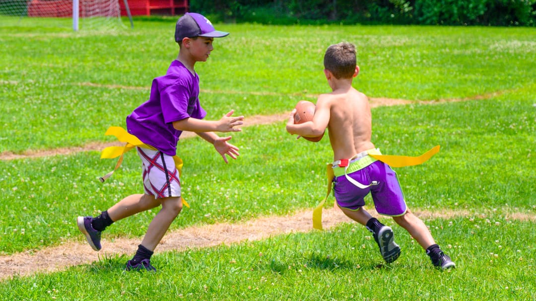 Boys playing football on field