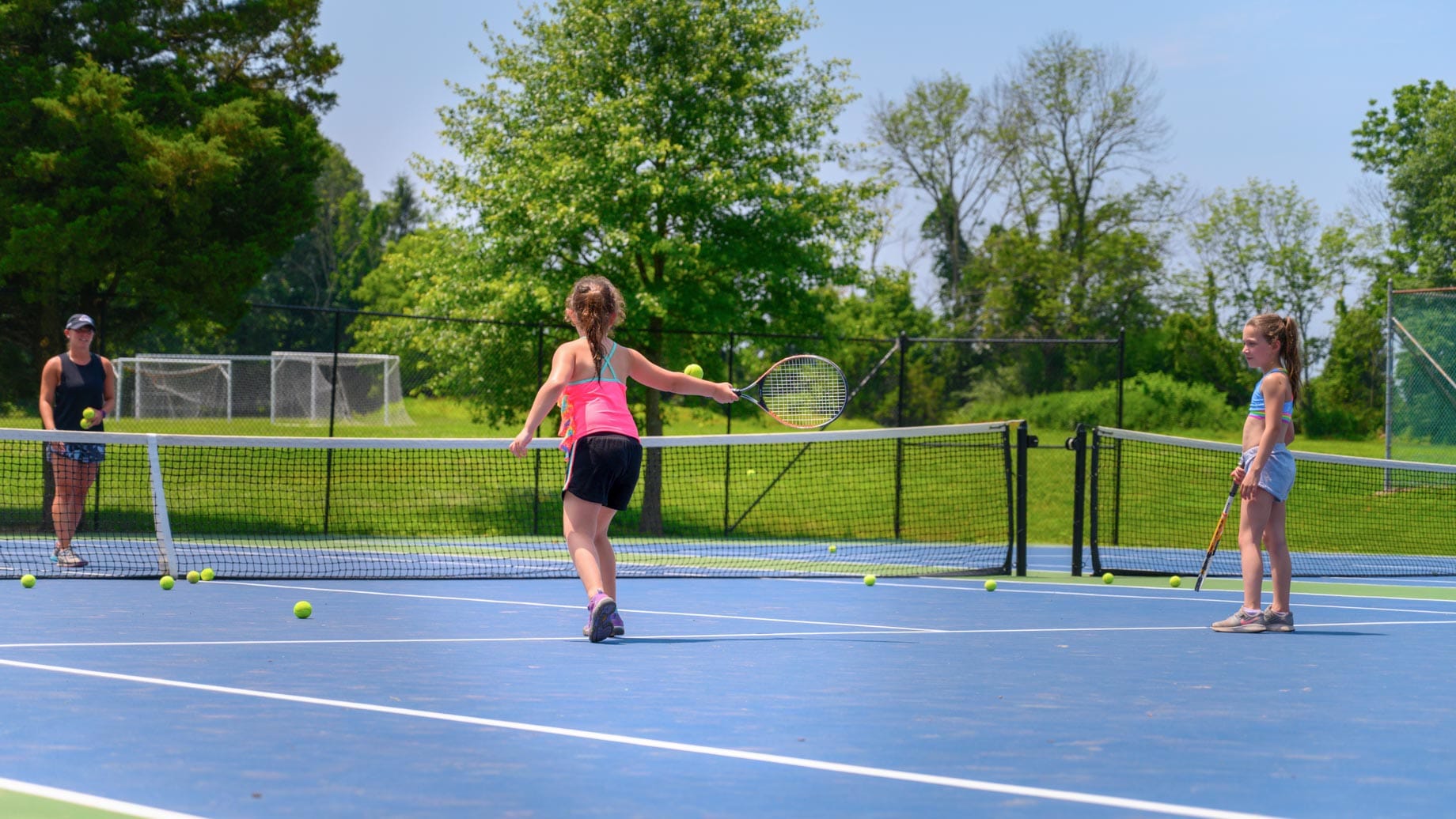 Girls playing tennis on the court