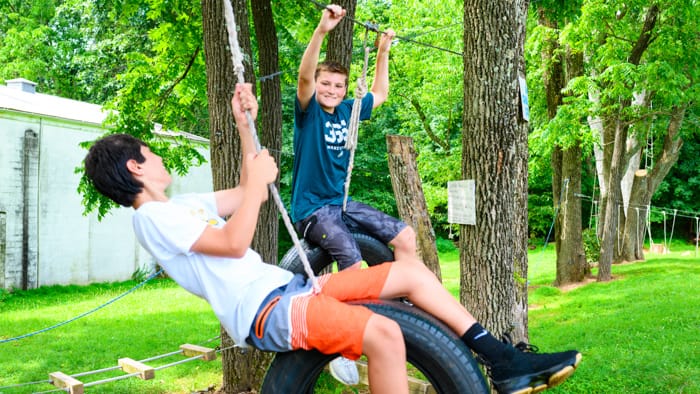 Boys on tire swings