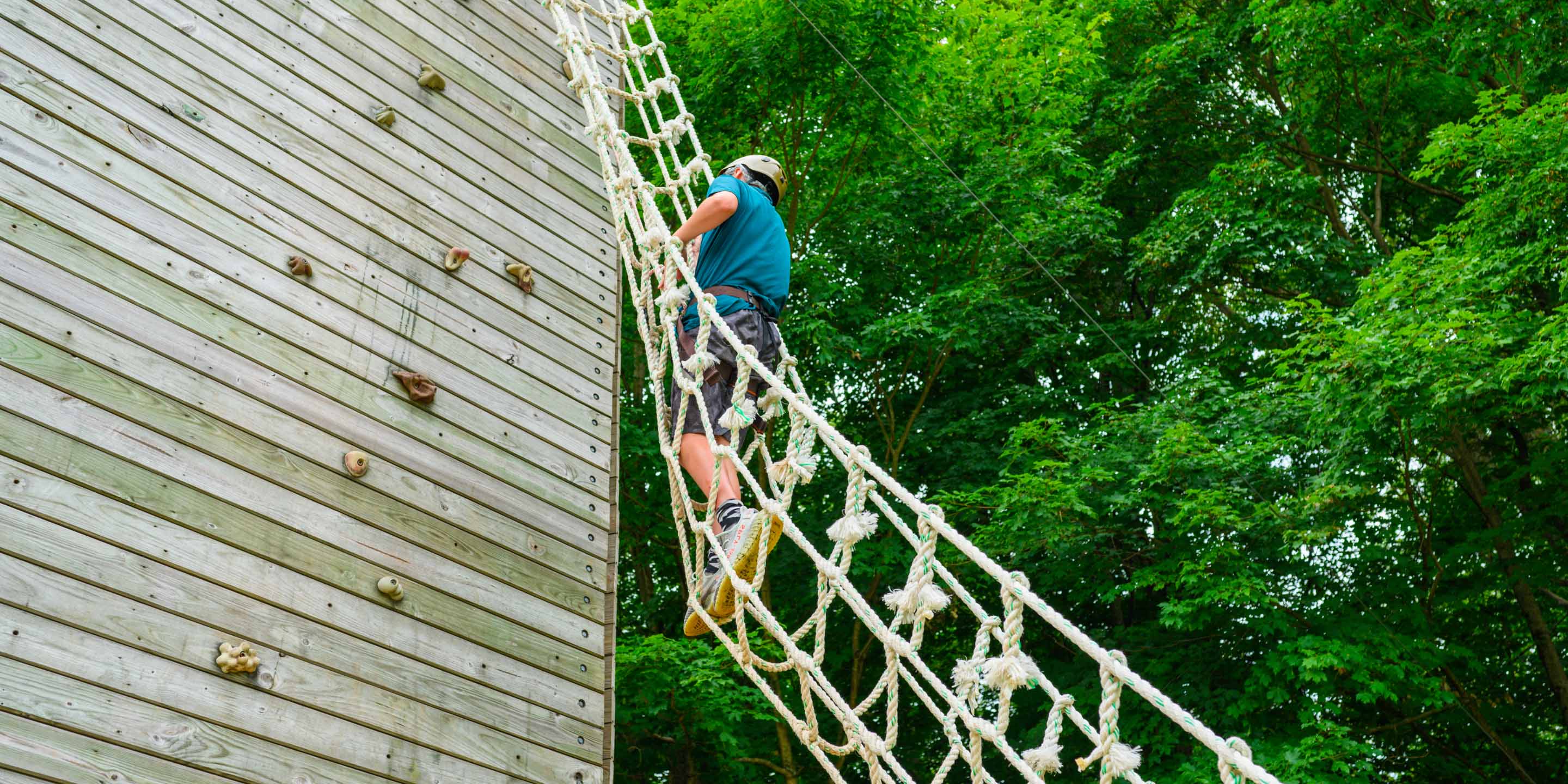 Camper going up ropes course