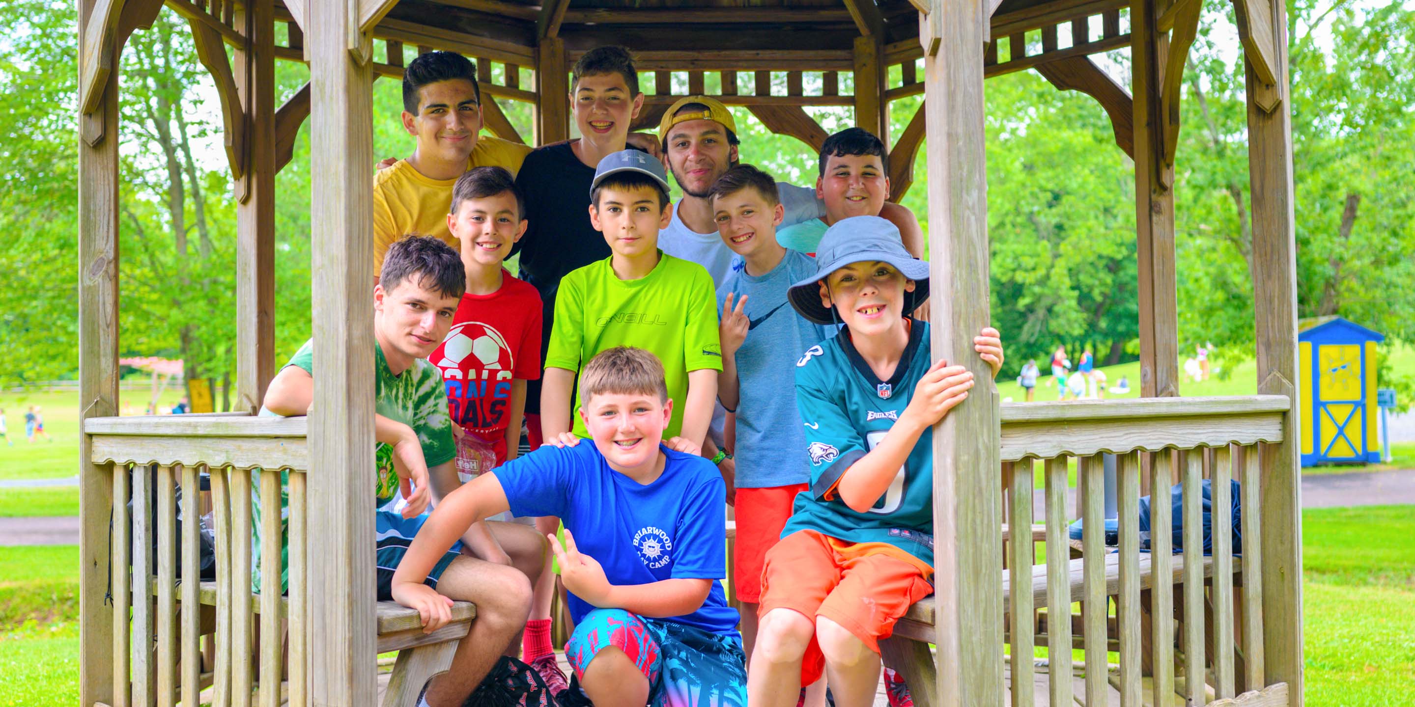 Boys sitting in the gazebo with staff