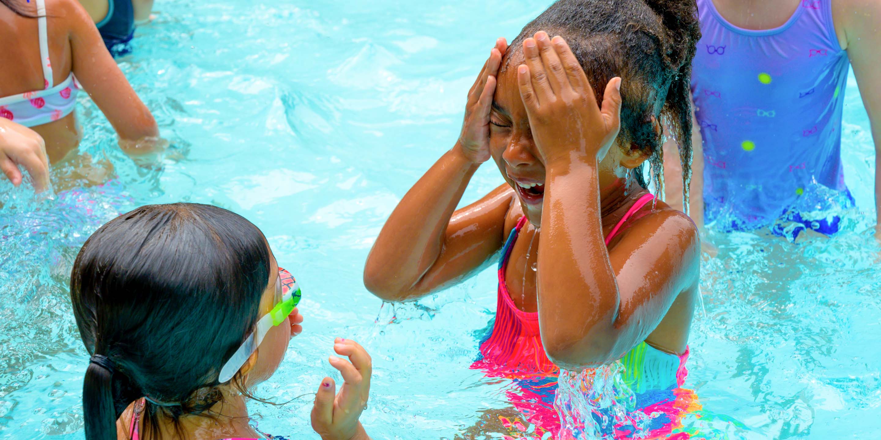 Girls swimming and laughing