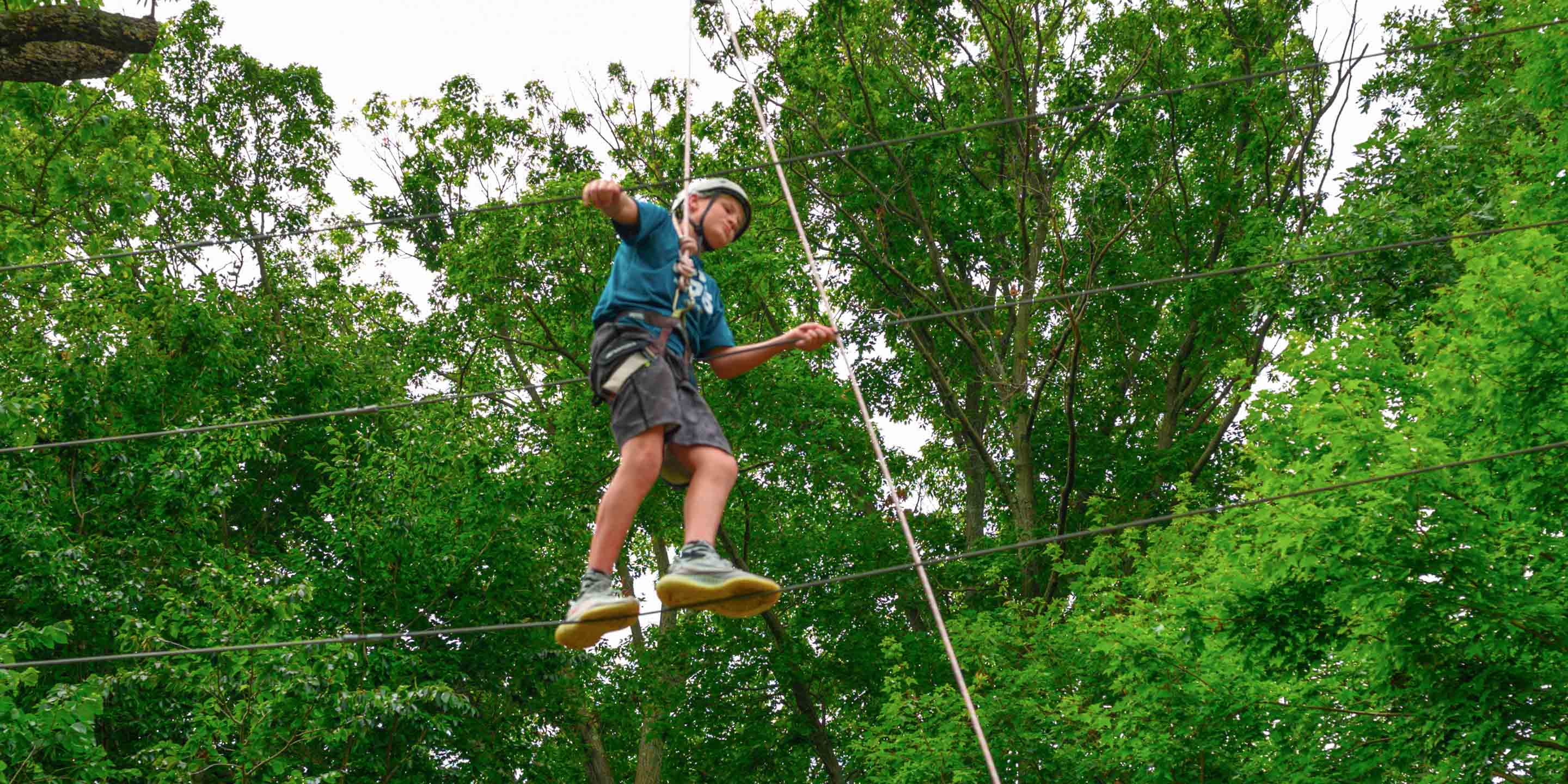 Camper on high ropes course