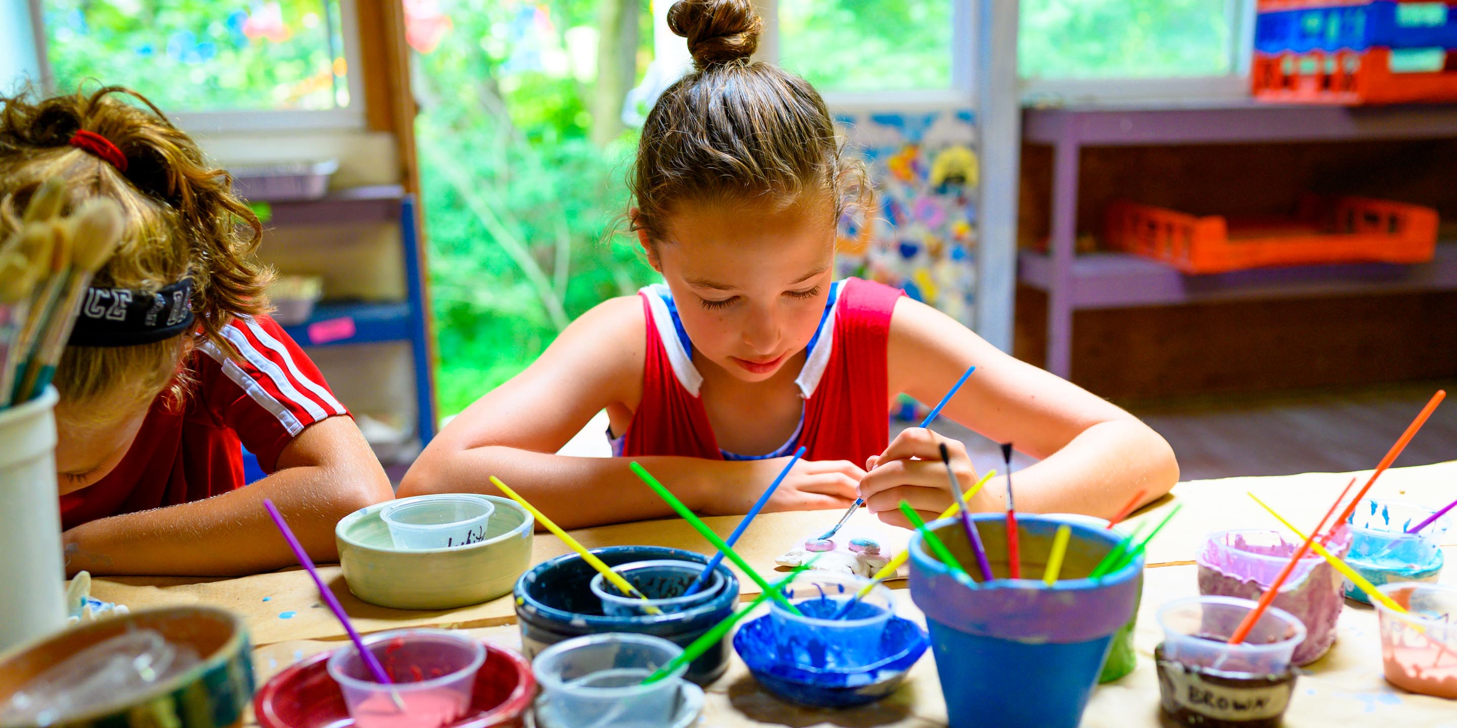 Camper painting during arts & crafts