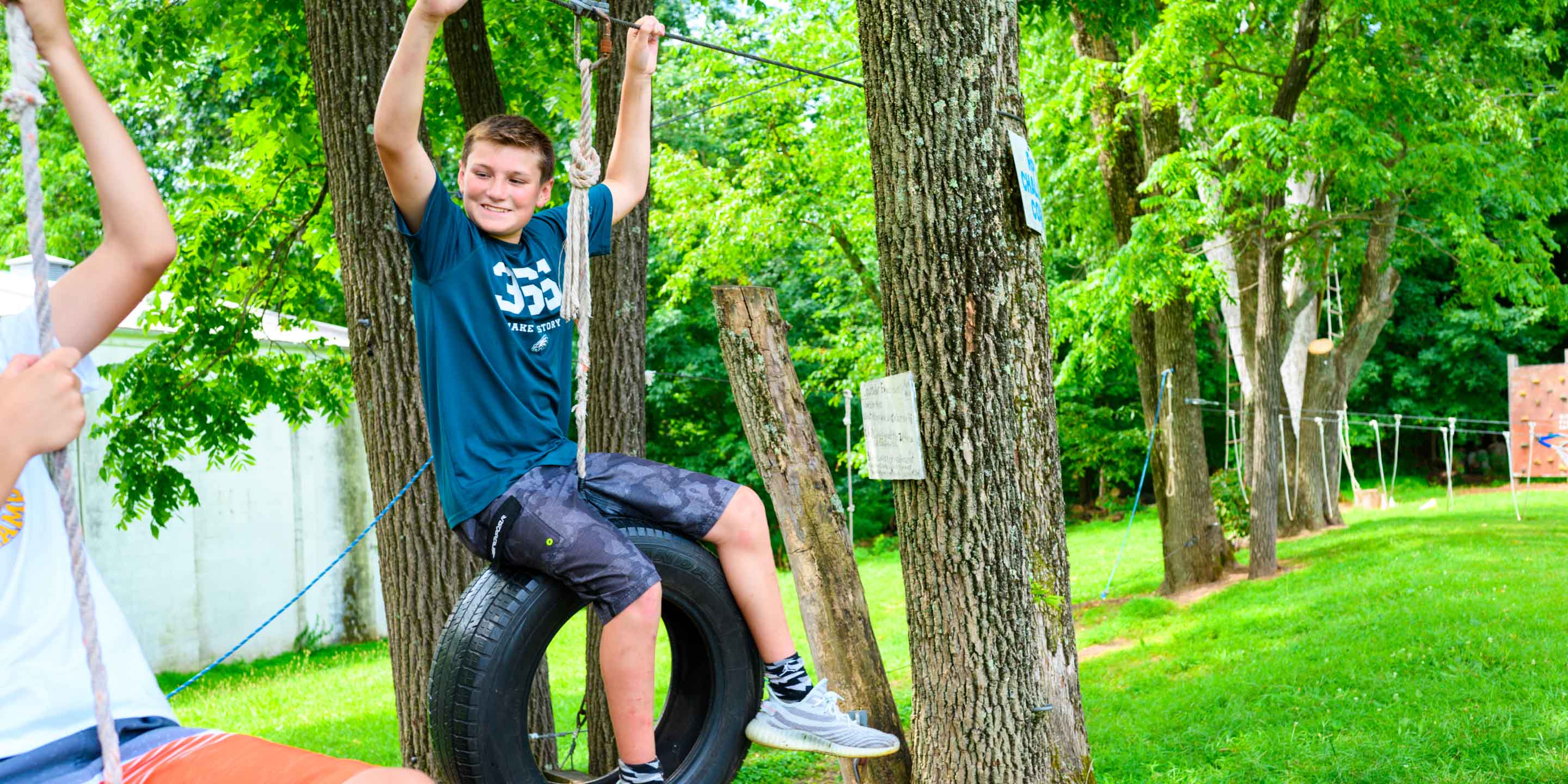 Camper sitting on tire swing