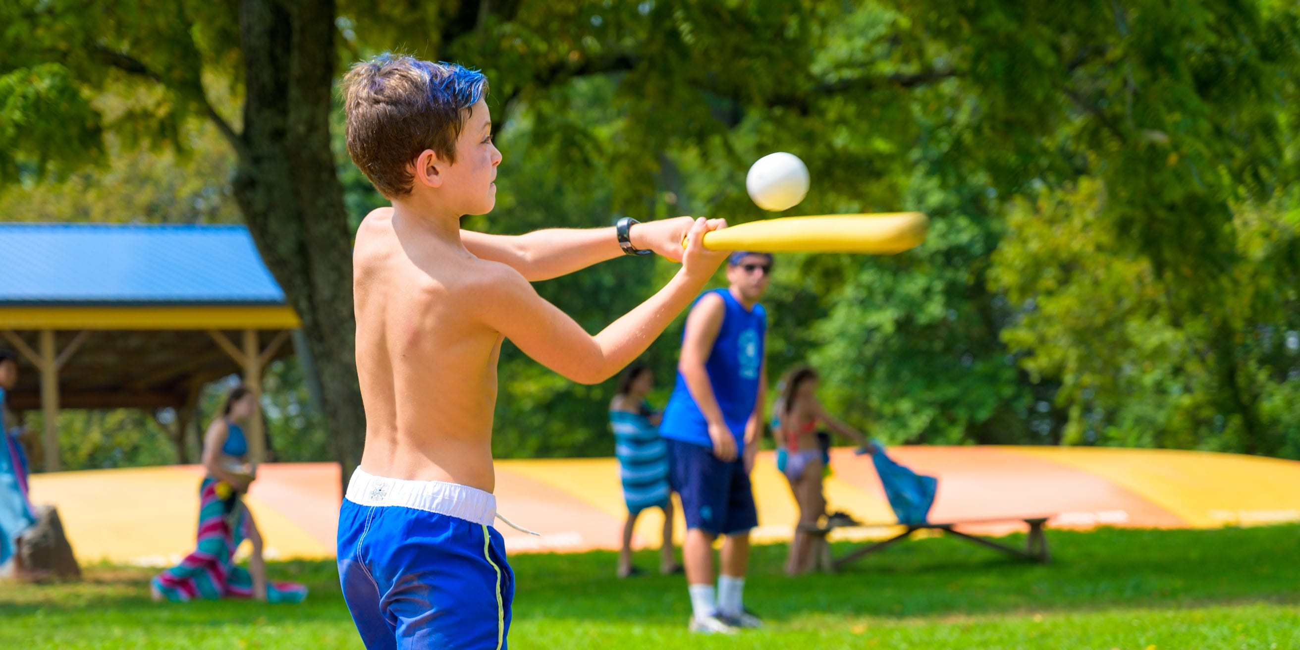 Camper hitting a baseball bat