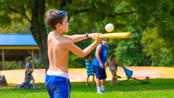 Camper hitting baseball bat