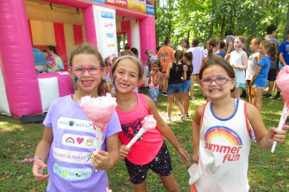 Girls at carnival eating cotton candy