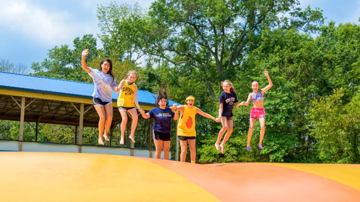 Girls on jumping pillow