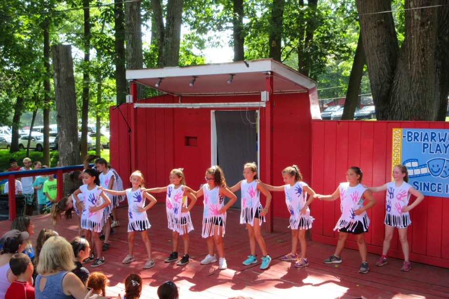 Girls performing dance on stage