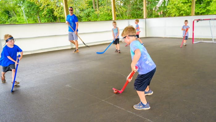 Young boys and staff playing hockey