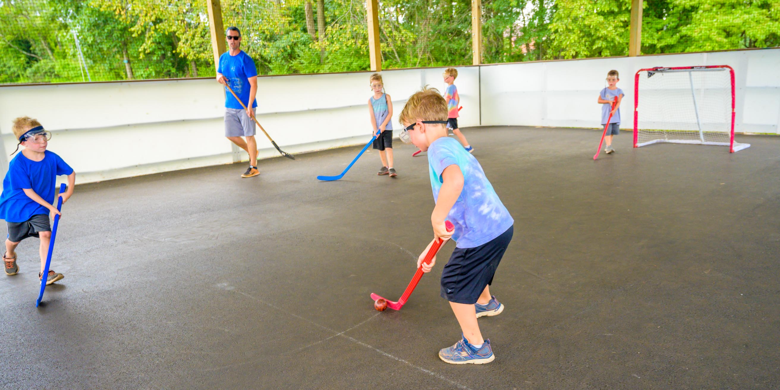 Young boys and staff playing hockey