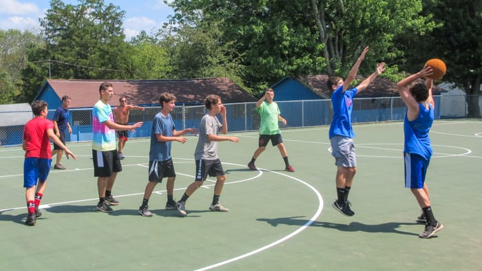 School group playing basketball