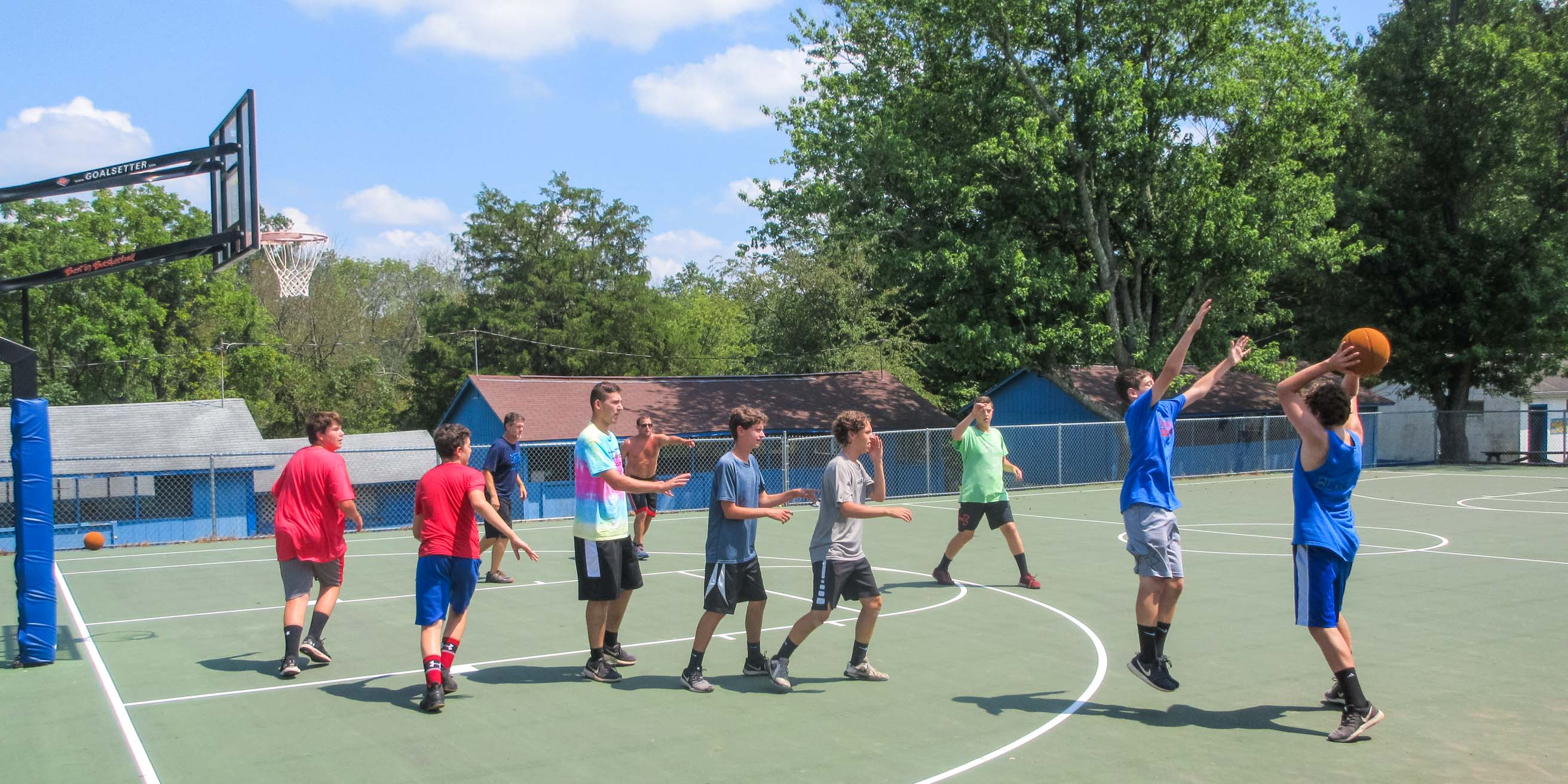 School group playing basketball