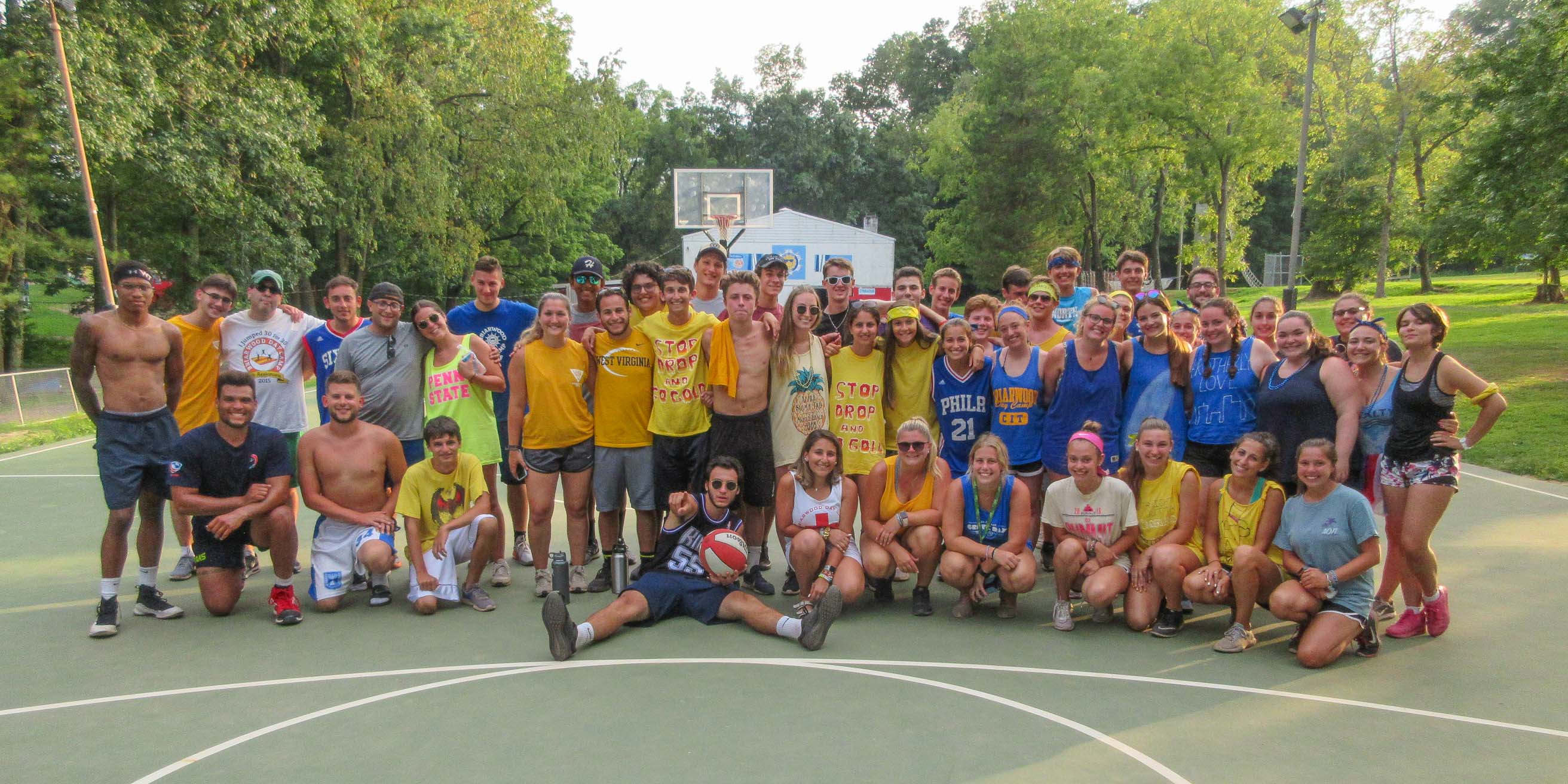 Staff group on basketball court smiling