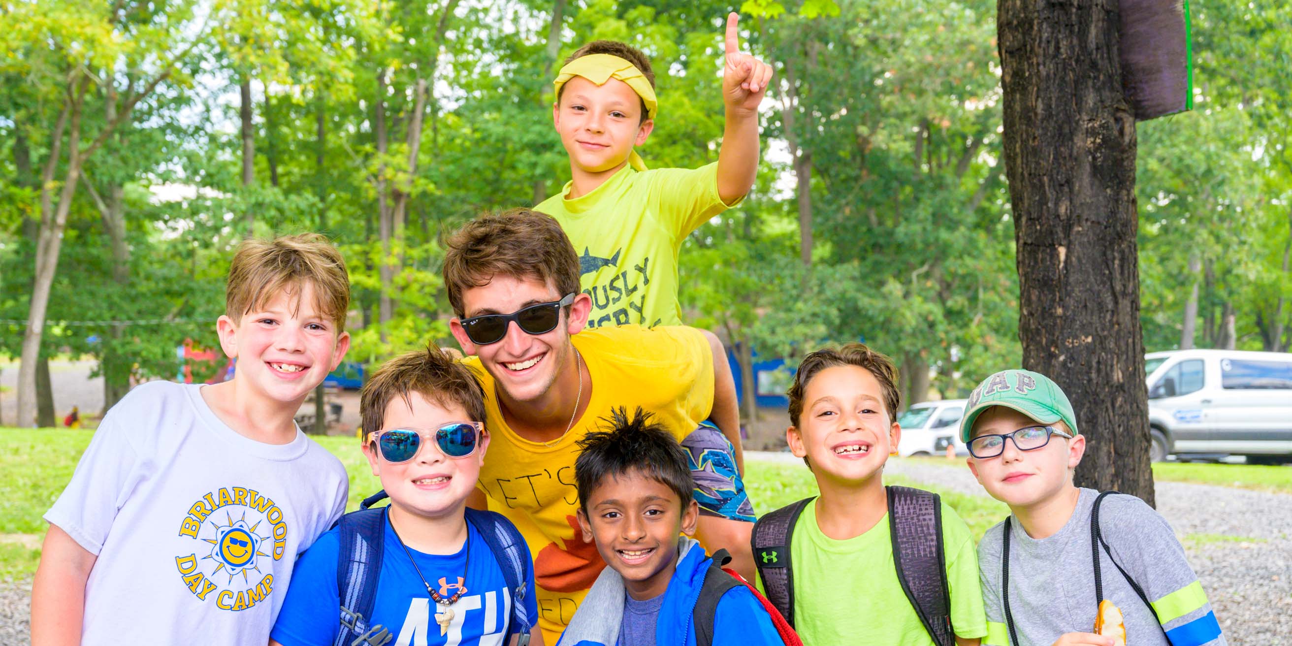 Boys smiling and giving "number one" hand signal