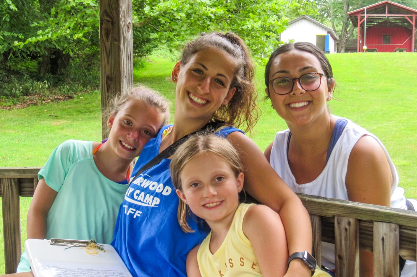 Female staff with campers smiling