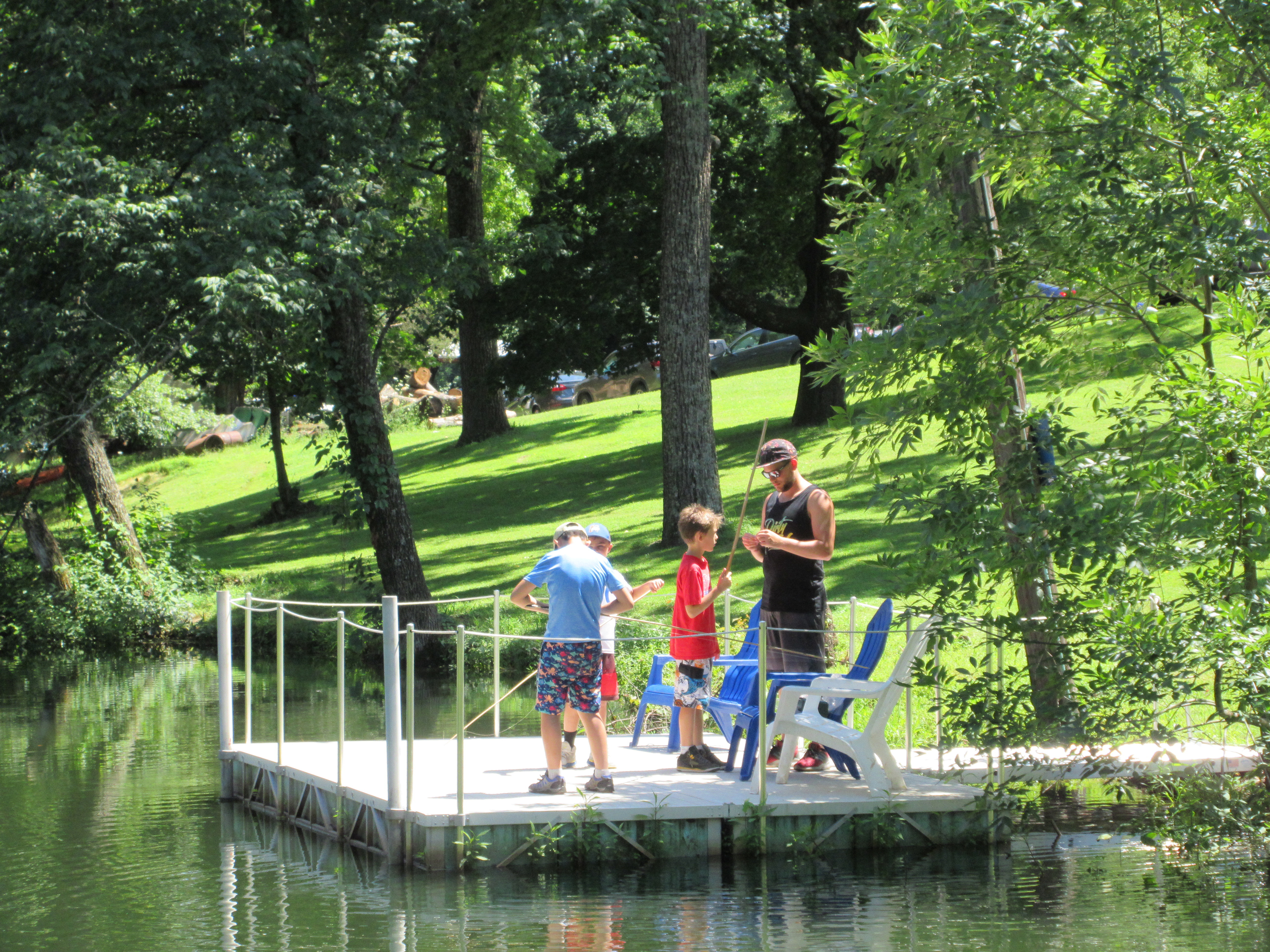 a counselor showing campers how to fish